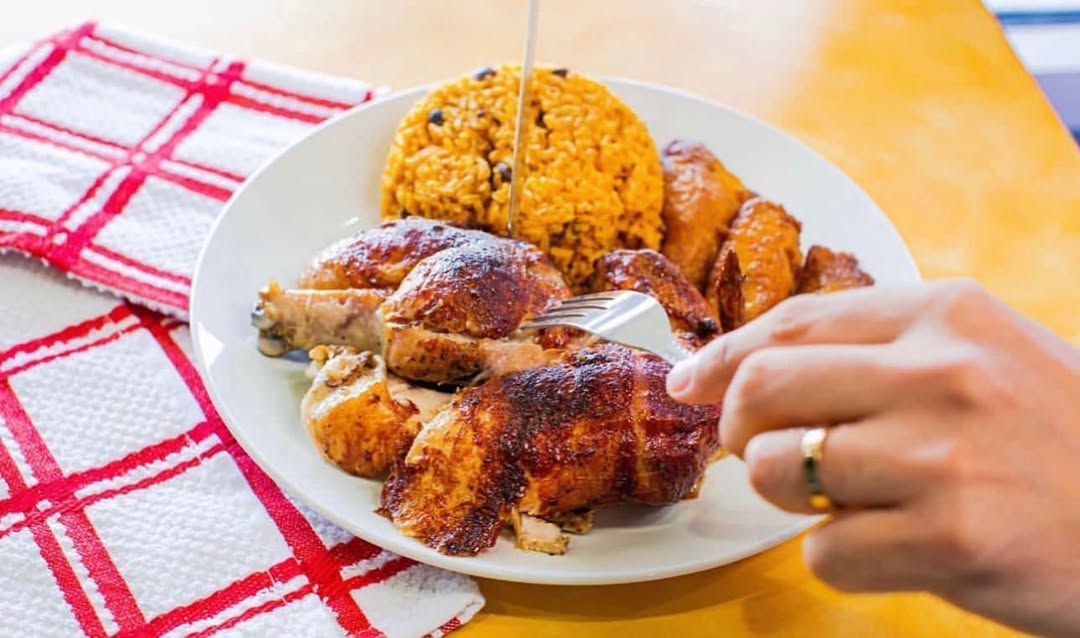 Delicious Piocos Chicken Plate with rotisserie chicken, yellow rice, and plantains
